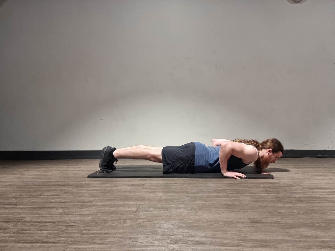 A man performing a press up to full depth